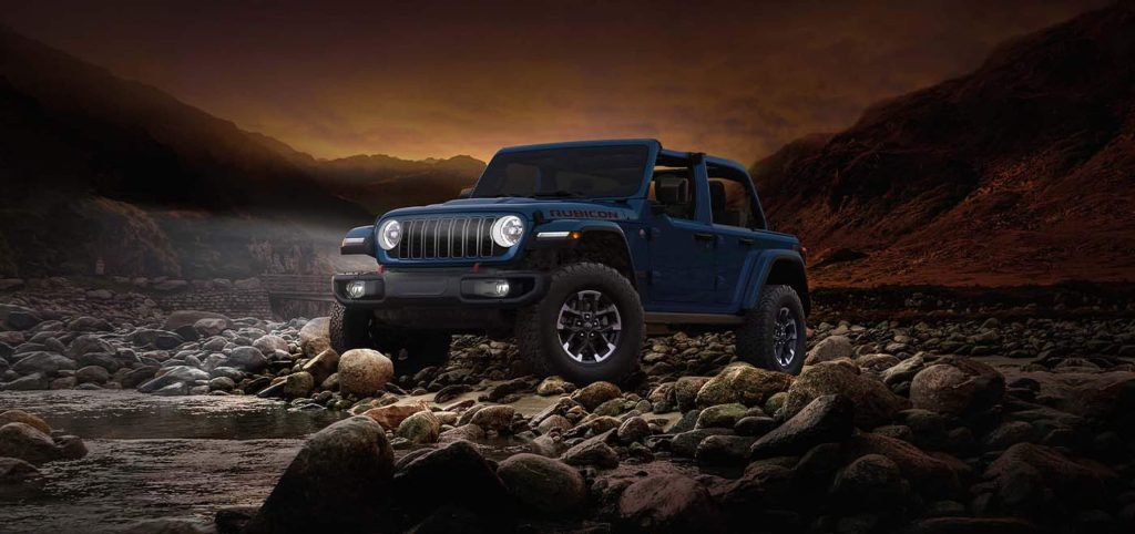 blue Jeep wrangler in sunset